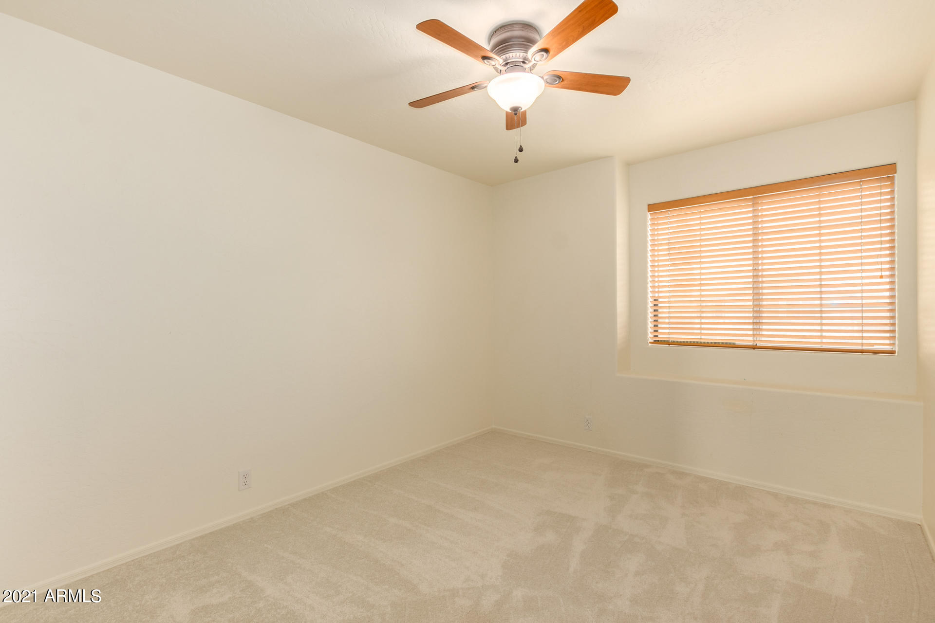 4244 East Raven Road Phoenix, AZ 85044 - Photo 20 of 31 an empty room with a window and a fan