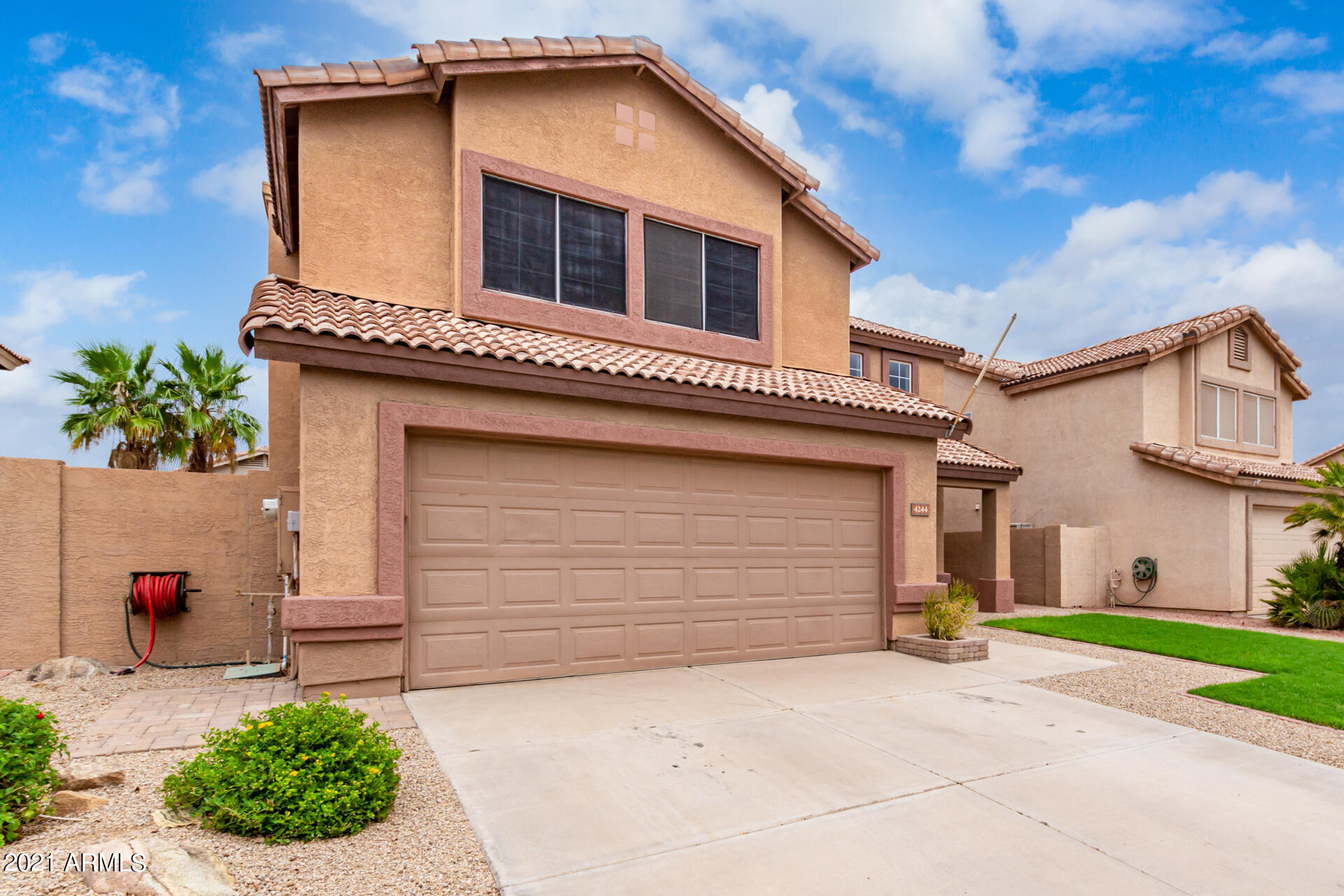 4244 East Raven Road Phoenix, AZ 85044 - Photo 2 of 31 a front view of a house with a yard and garage