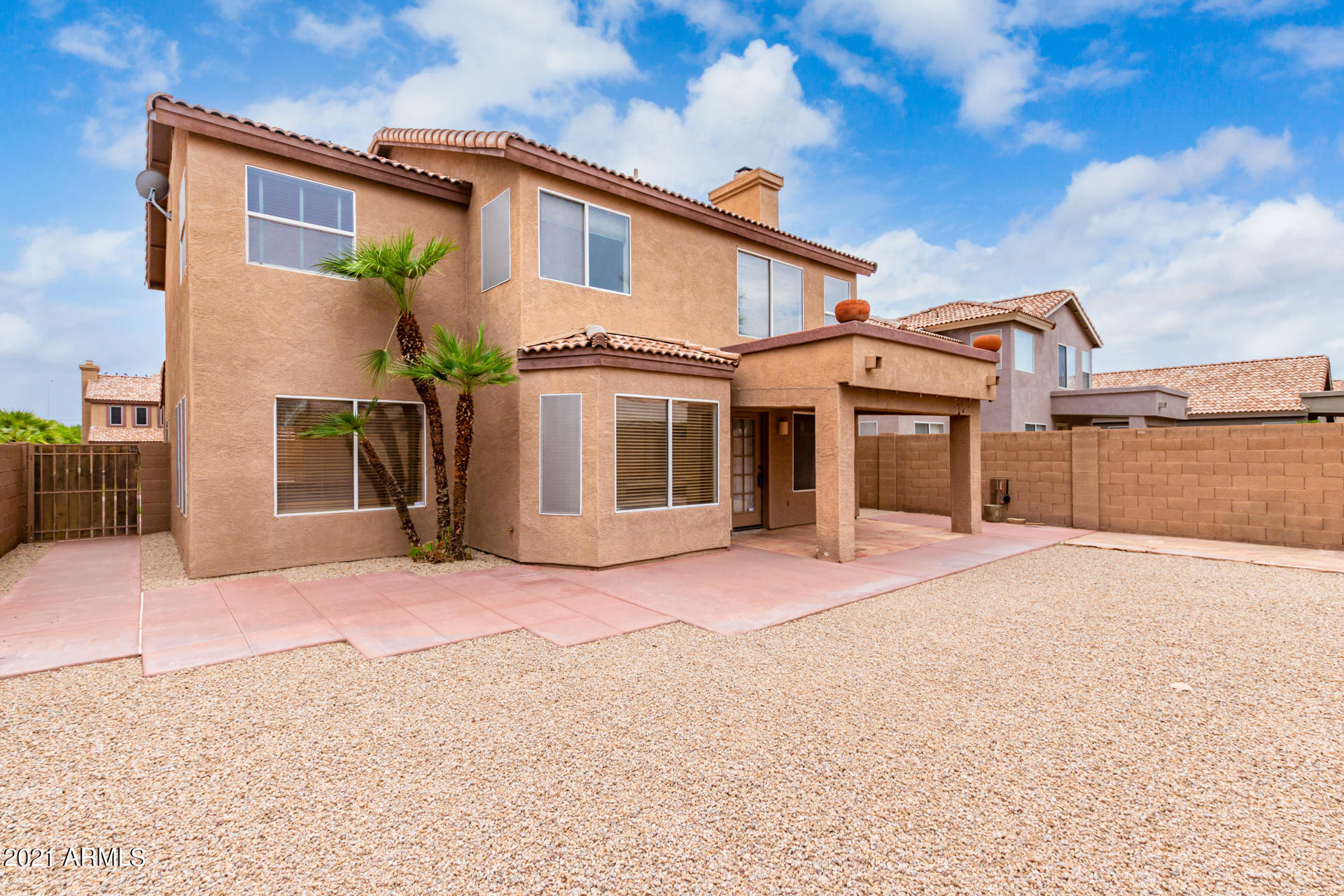 4244 East Raven Road Phoenix, AZ 85044 - Photo 25 of 31 a front view of a house with a yard and garage