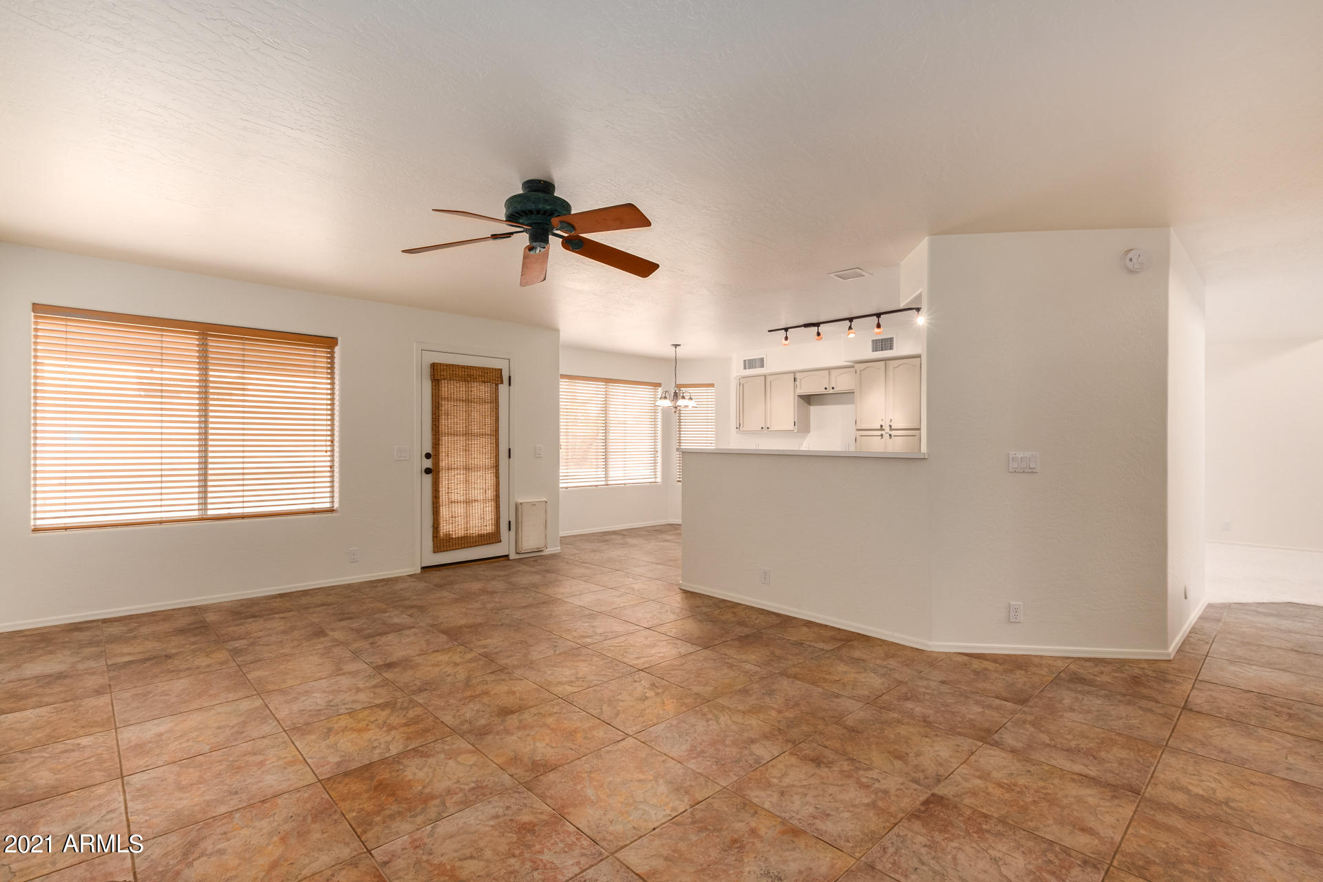 4244 East Raven Road Phoenix, AZ 85044 - Photo 7 of 31 a view of a kitchen with furniture and a ceiling fan