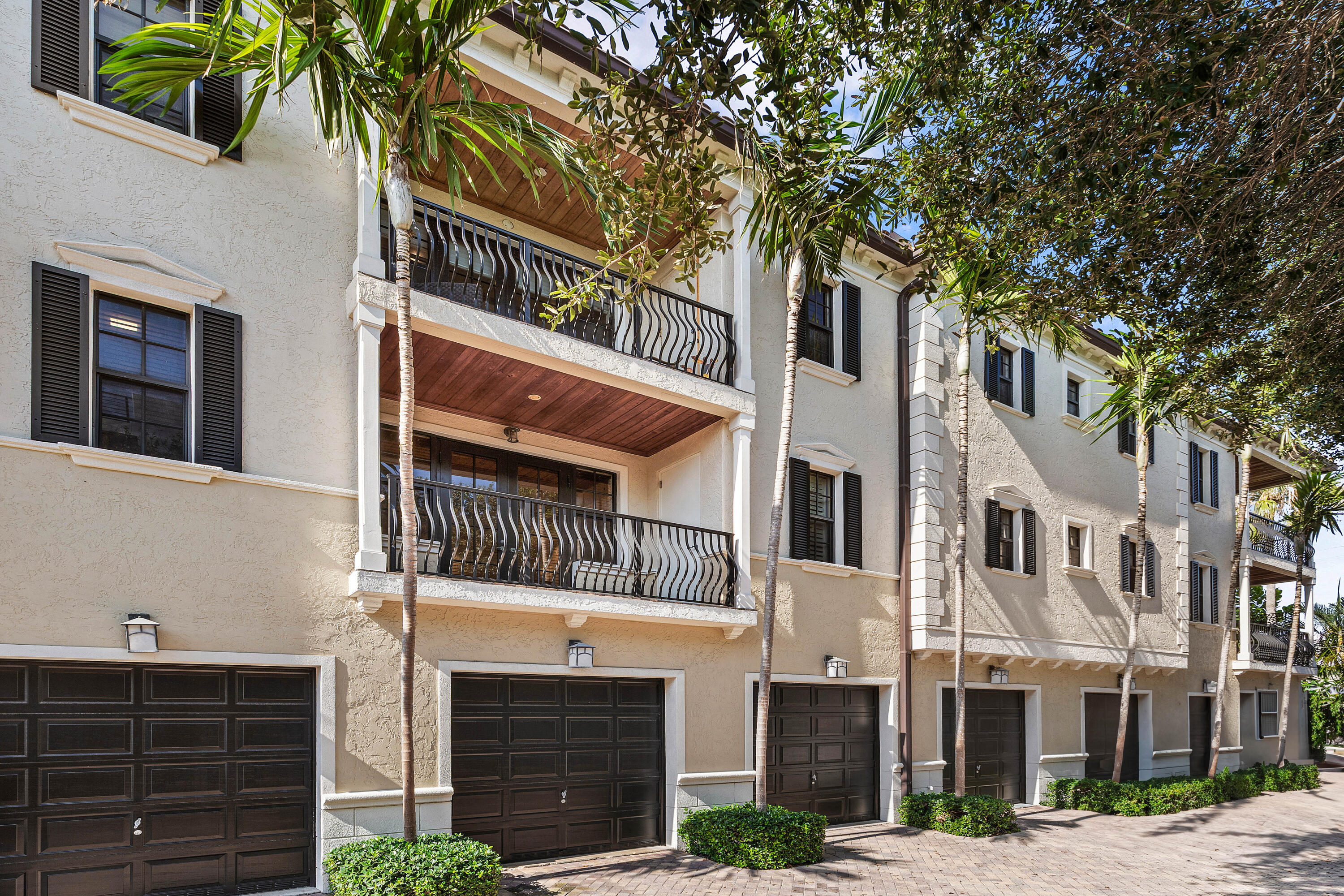 110 Gleason Street, Unit 203 Delray Beach, FL 33483 - Photo 24 of 25 a front view of a multi story residential apartment building with a yard