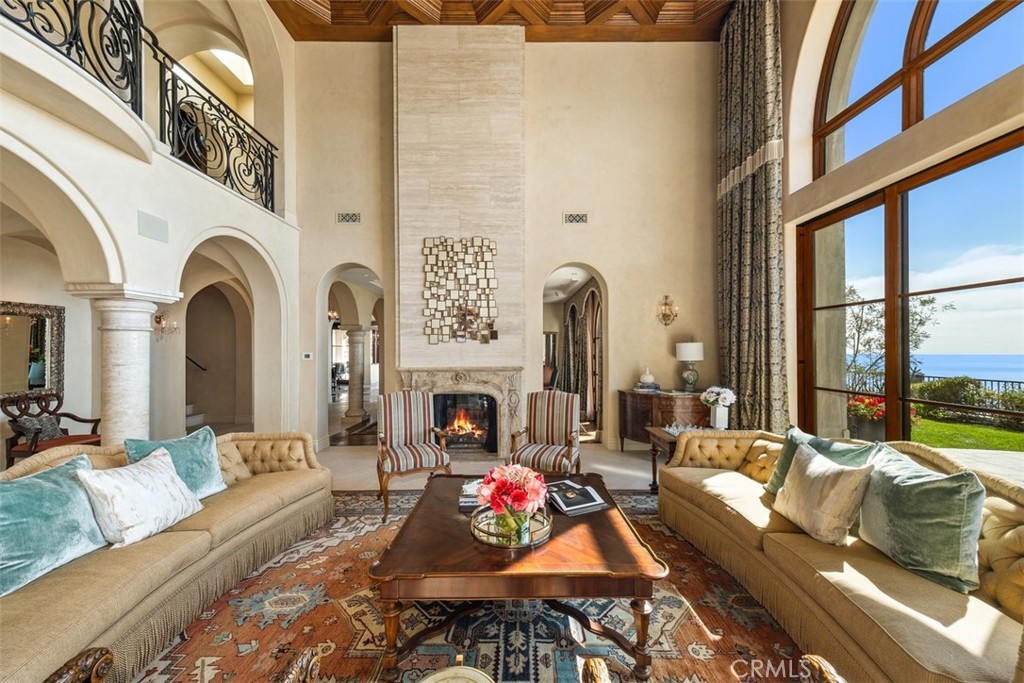 32040 Cape Point Drive Rancho Palos Verdes, CA 90275 - Photo 17 of 70 a living room with fireplace furniture and a floor to ceiling window