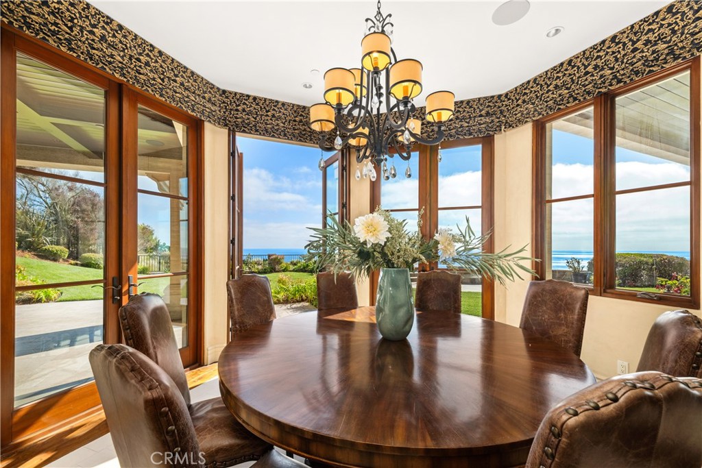 32040 Cape Point Drive Rancho Palos Verdes, CA 90275 - Photo 35 of 70 a view of a dining room with furniture large windows and wooden floor
