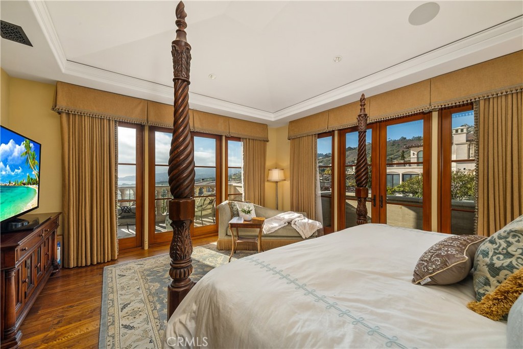 32040 Cape Point Drive Rancho Palos Verdes, CA 90275 - Photo 51 of 70 a bedroom with a large bed and a flat tv screen
