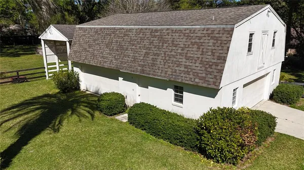 a aerial view of a house with a yard