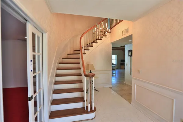 a view of entryway and hall with wooden floor