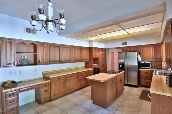 a kitchen with refrigerator and cabinets