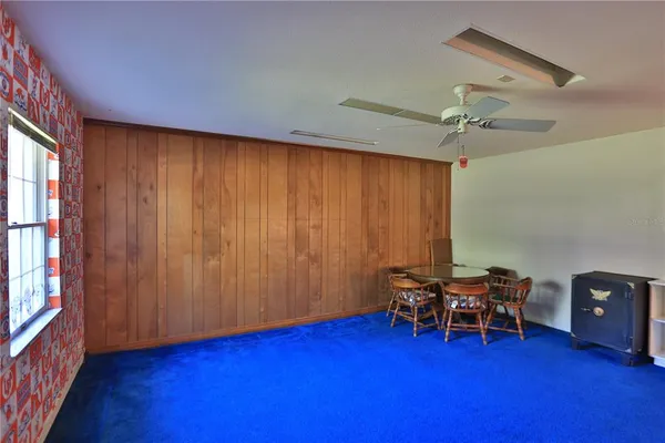 a view of room with lounge chair and wooden floor