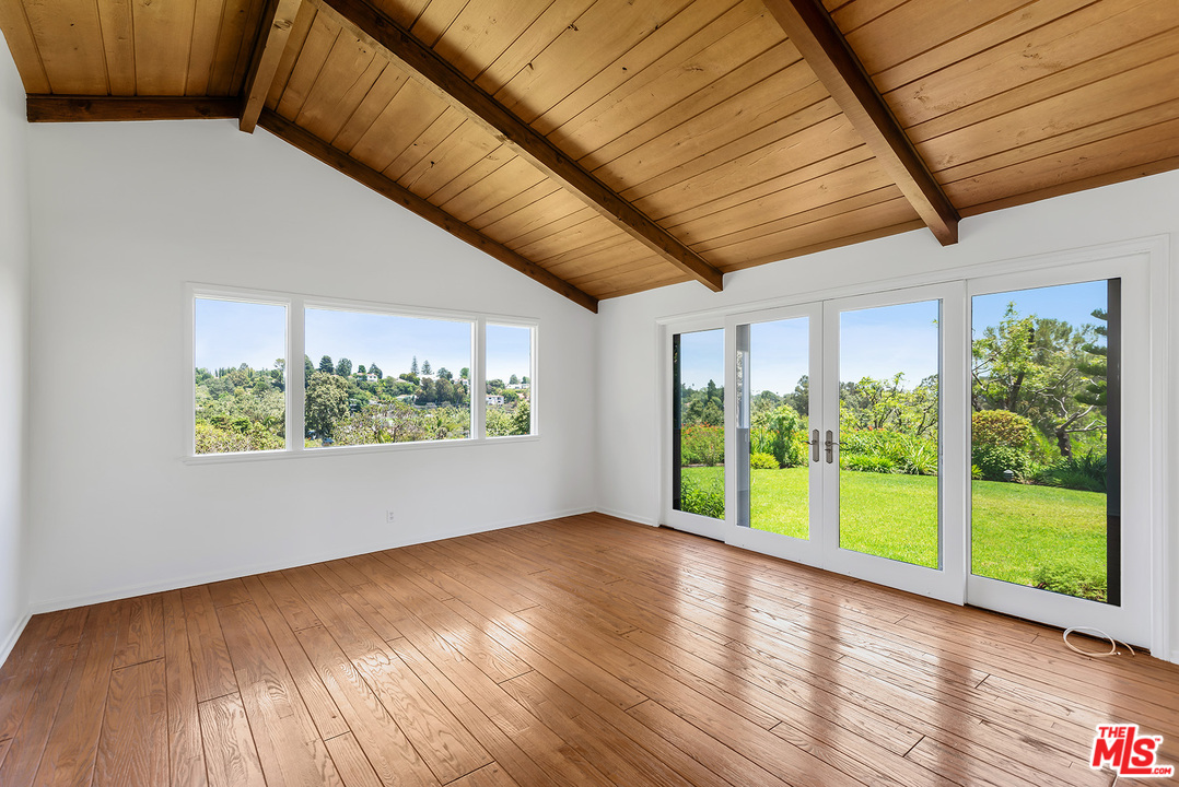 13238 Riviera Ranch Road Los Angeles, CA 90049 - Photo 16 of 28 a view of room with window and wooden floor