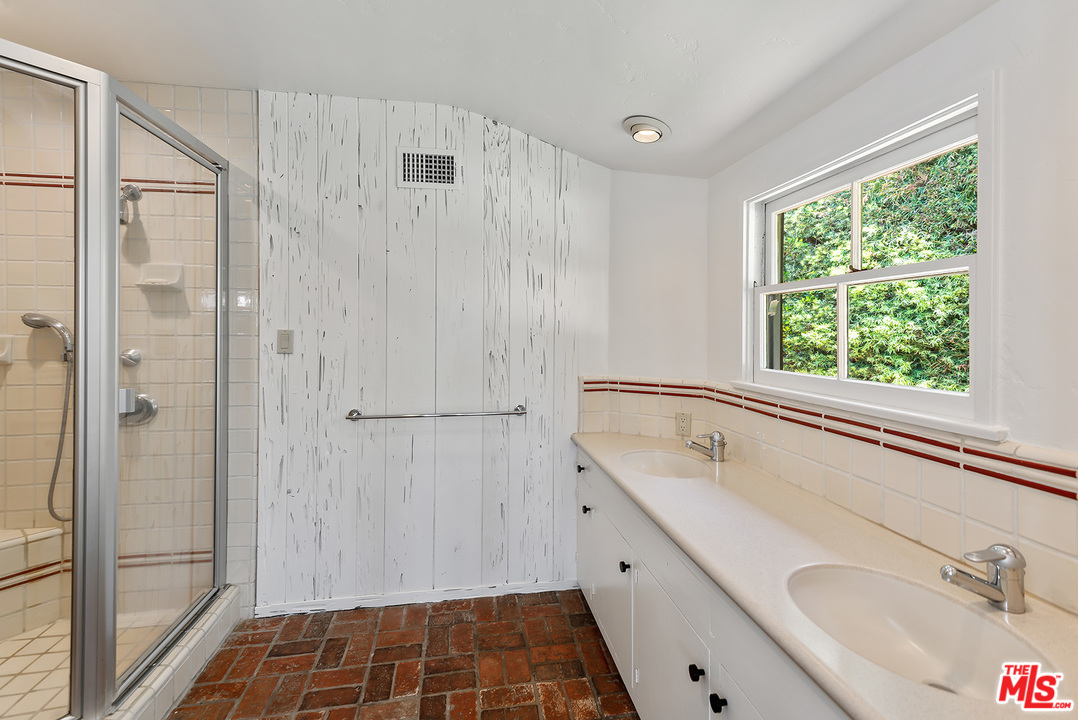 13238 Riviera Ranch Road Los Angeles, CA 90049 - Photo 19 of 28 a bathroom with a tub sink and shower
