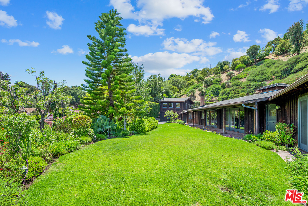 13238 Riviera Ranch Road Los Angeles, CA 90049 - Photo 2 of 28 a view of house with backyard and garden