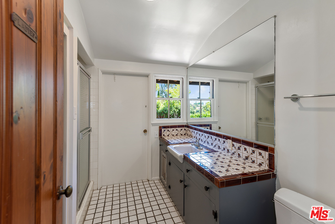 13238 Riviera Ranch Road Los Angeles, CA 90049 - Photo 24 of 28 a view of a hallway with windows