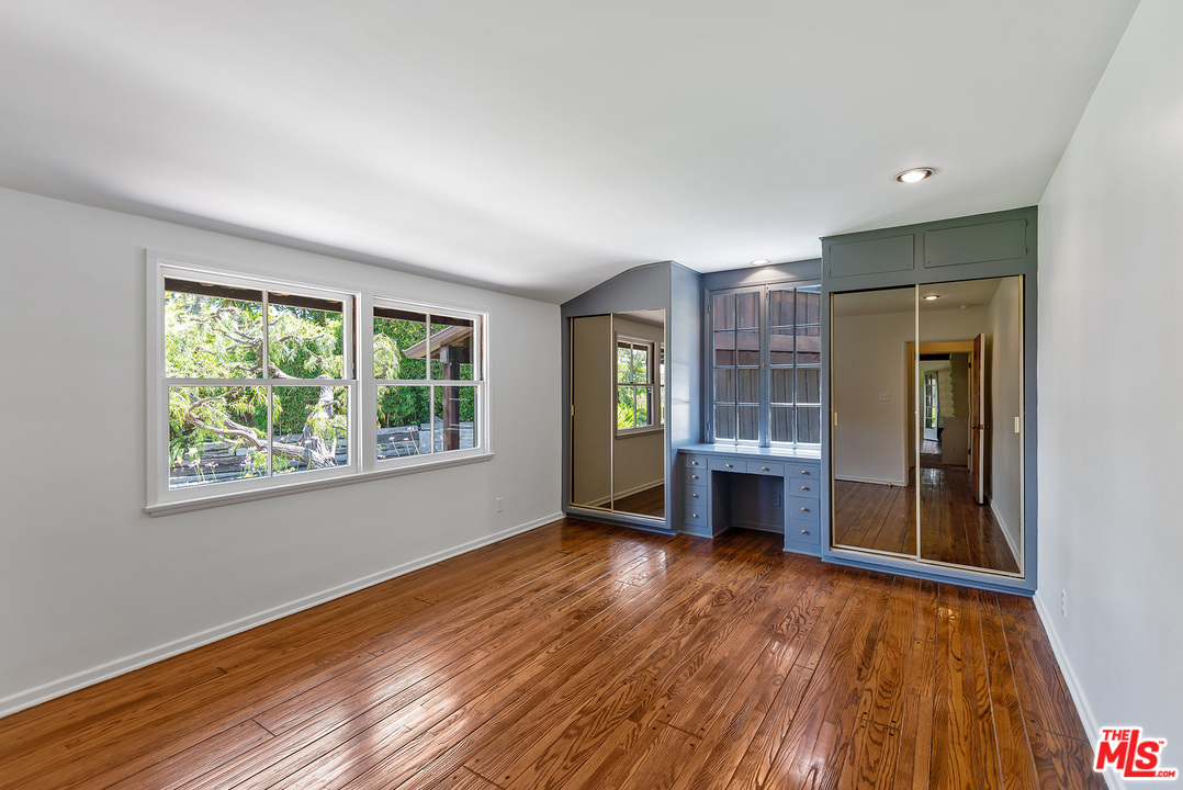 13238 Riviera Ranch Road Los Angeles, CA 90049 - Photo 25 of 28 a view of an empty room with wooden floor and a window