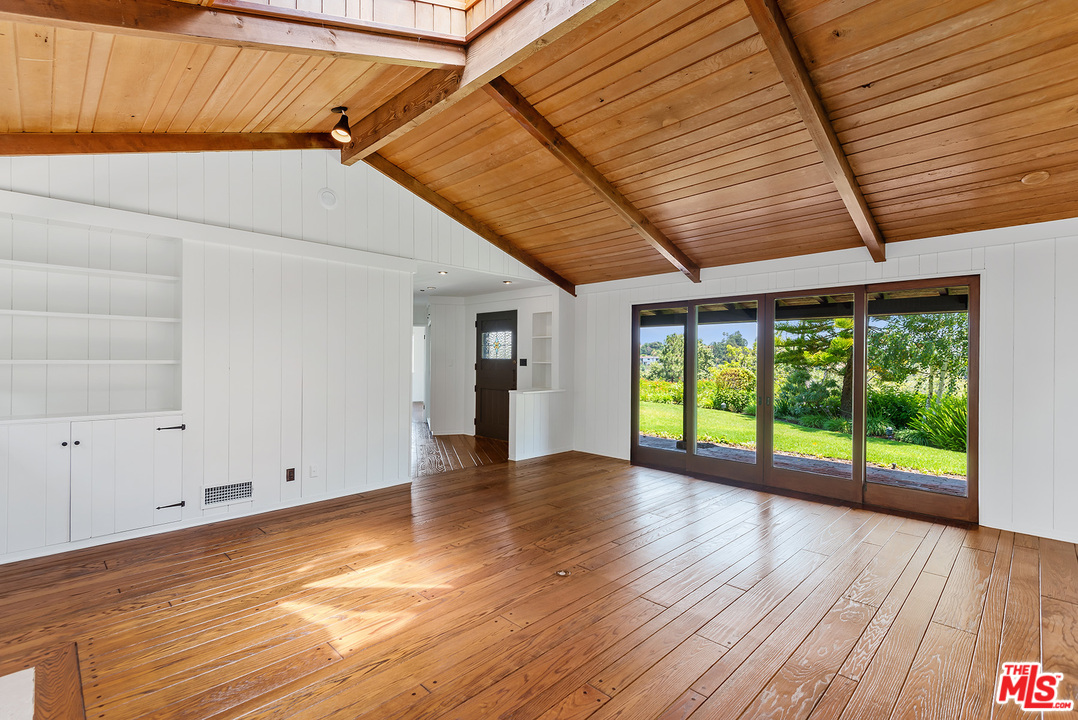 13238 Riviera Ranch Road Los Angeles, CA 90049 - Photo 8 of 28 a view of room with window and wooden floor