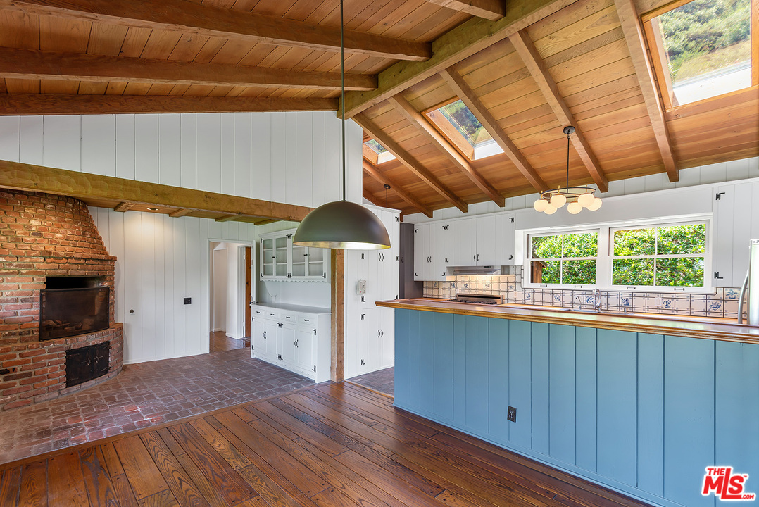 13238 Riviera Ranch Road Los Angeles, CA 90049 - Photo 10 of 28 a view of a kitchen with a sink and wooden cabinets