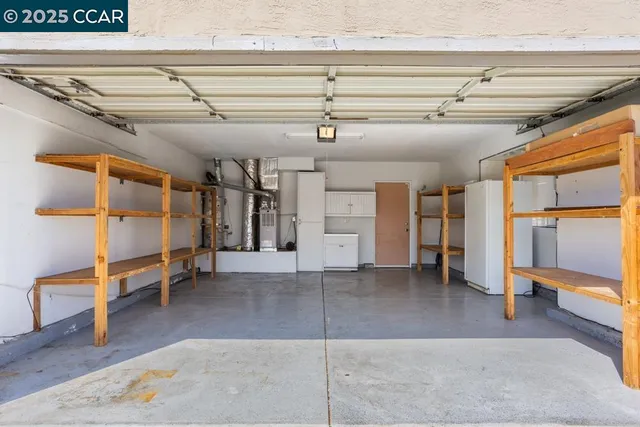 a view of a room with wooden floor and furniture