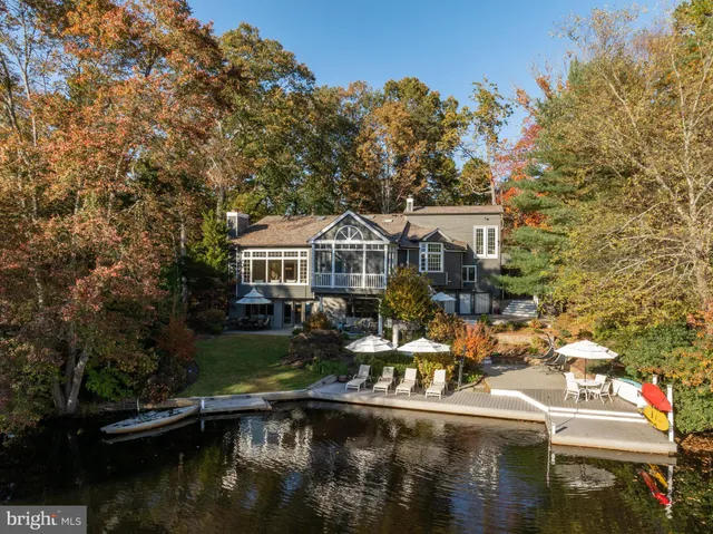 a view of brick house with large windows and potted plants