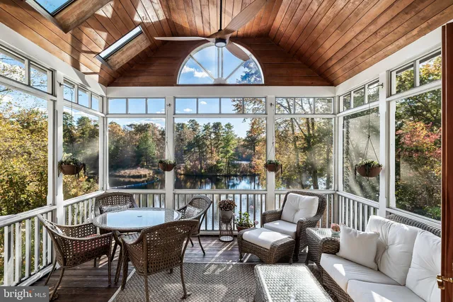 a view of a roof deck with table and chairs under an umbrella