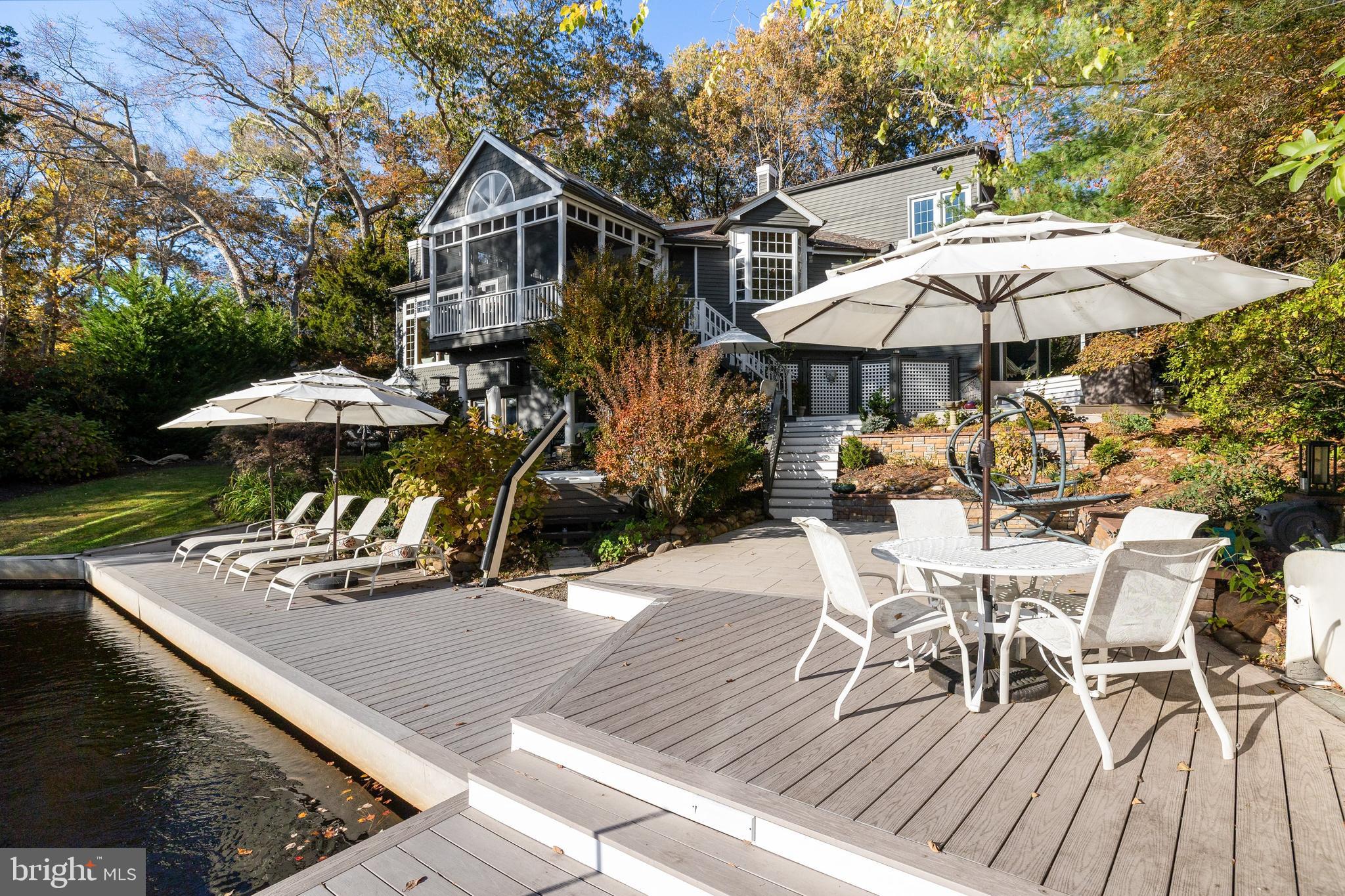 286 Chippewa Trail Medford Lakes, NJ 08055 - Photo 72 of 120 a view of a roof deck with table and chairs under an umbrella