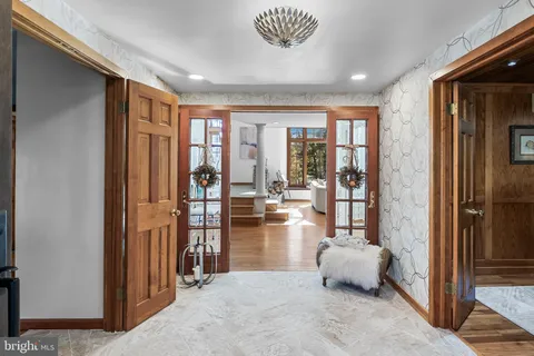 a very nice looking living room with a large window and a chandelier