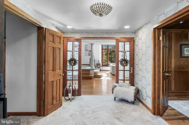 a very nice looking living room with a large window and a chandelier