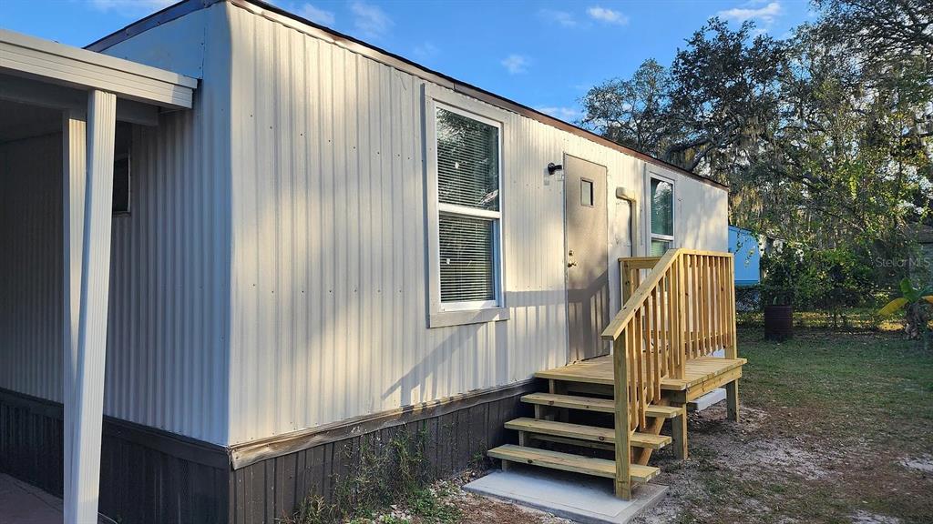 837 Ethyl Street, Unit B Brandon, FL 33511 - Photo 1 of 12 a view of a balcony with stairs and wooden floor