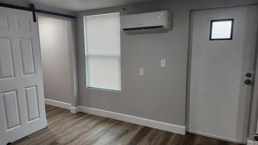 837 Ethyl Street, Unit B Brandon, FL 33511 - Photo 2 of 12 a view of an empty room with wooden floor and a window