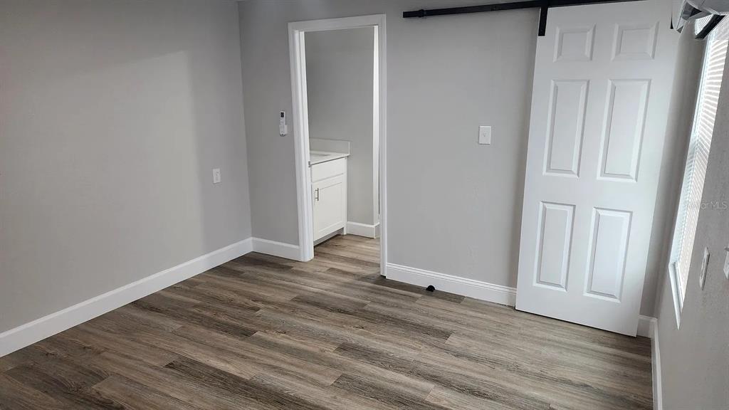 837 Ethyl Street, Unit B Brandon, FL 33511 - Photo 5 of 12 a view of an empty room with wooden floor