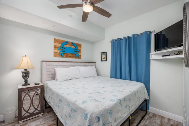 a bedroom with a bed and a chandelier