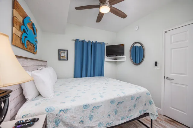 a bedroom with a bed and a chandelier