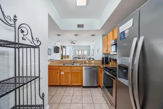 a kitchen with stainless steel appliances granite countertop a refrigerator and a stove top oven