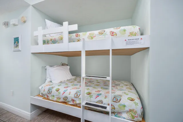 a bedroom with a bed and a dresser in it