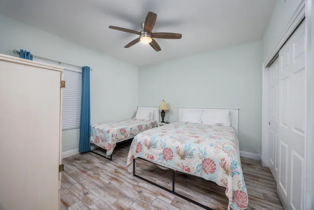 a bedroom with a bed and a ceiling fan
