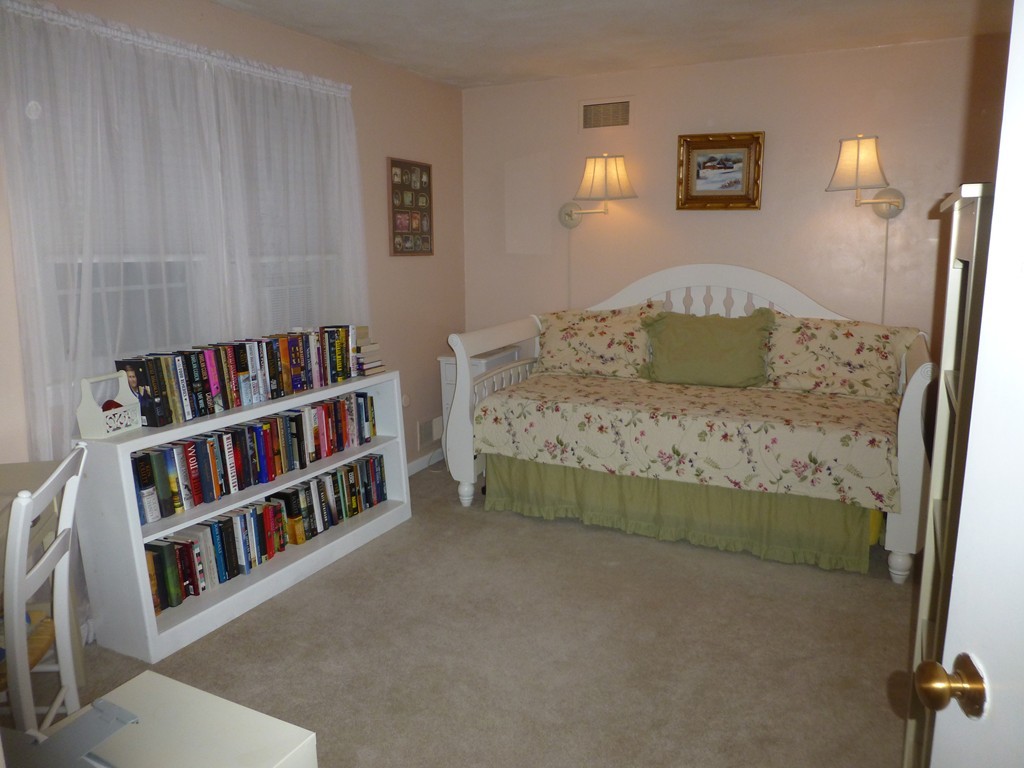 91 Drummer Road, Unit 91 Acton, MA 01720 - Photo 12 of 17 a bedroom with a bed and a book shelf