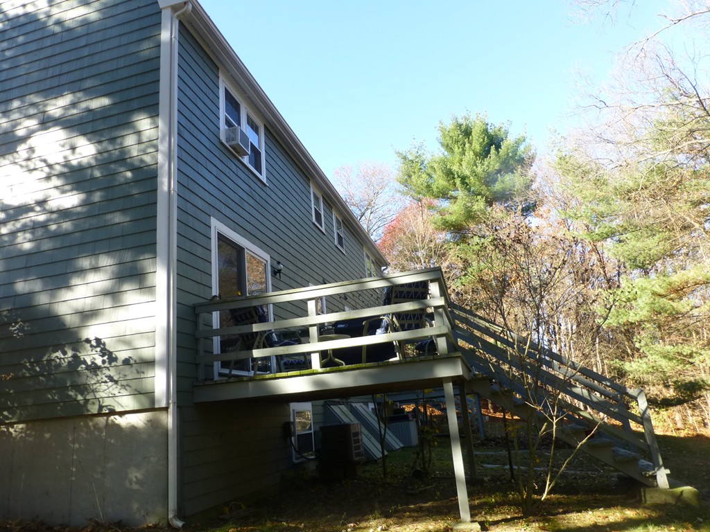 91 Drummer Road, Unit 91 Acton, MA 01720 - Photo 2 of 17 a backyard of a house with wooden floor and outdoor seating