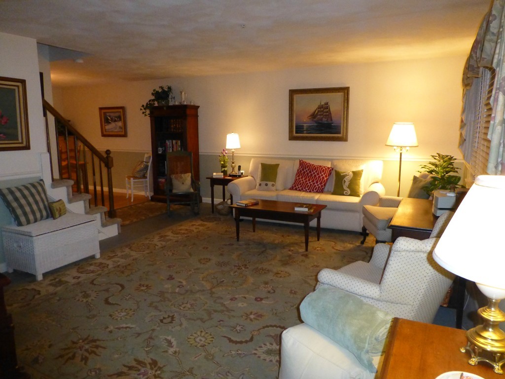 91 Drummer Road, Unit 91 Acton, MA 01720 - Photo 5 of 17 a living room with furniture and a lamp