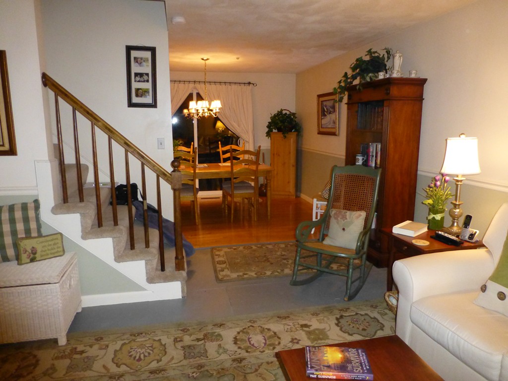 91 Drummer Road, Unit 91 Acton, MA 01720 - Photo 6 of 17 a living room with couches and a dining table with wooden floor
