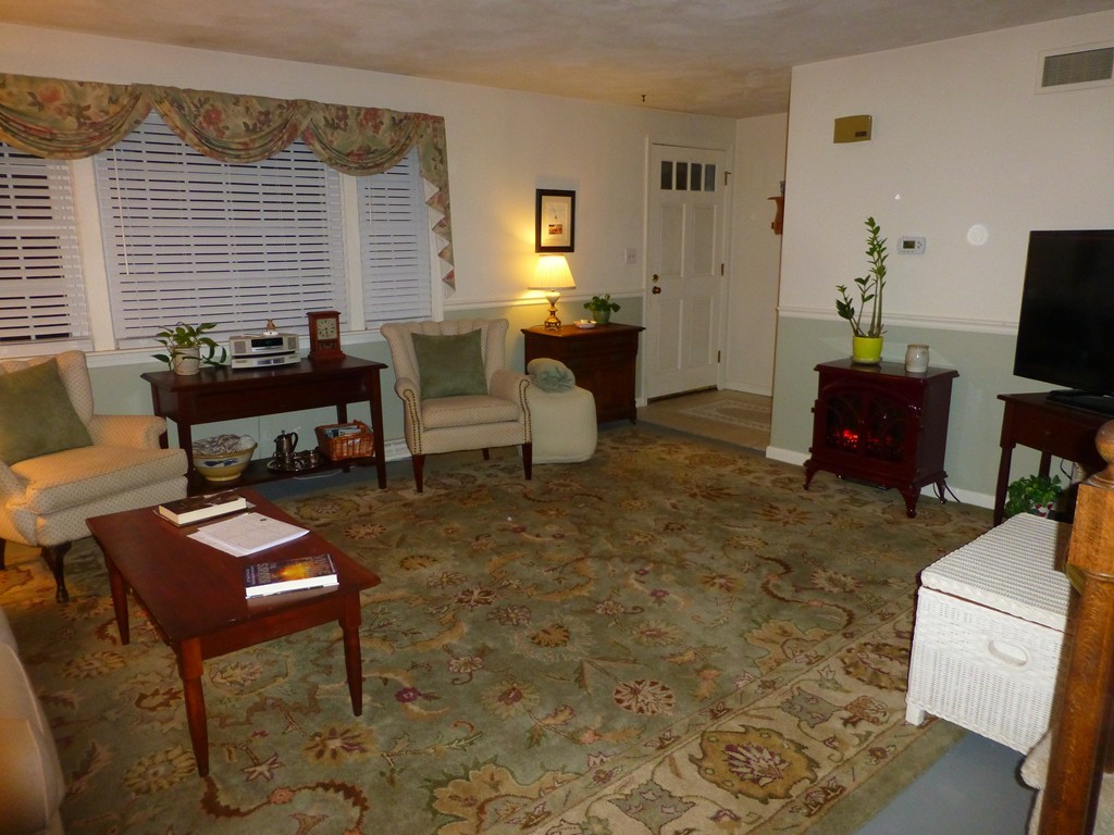 91 Drummer Road, Unit 91 Acton, MA 01720 - Photo 8 of 17 a living room with furniture and a flat screen tv