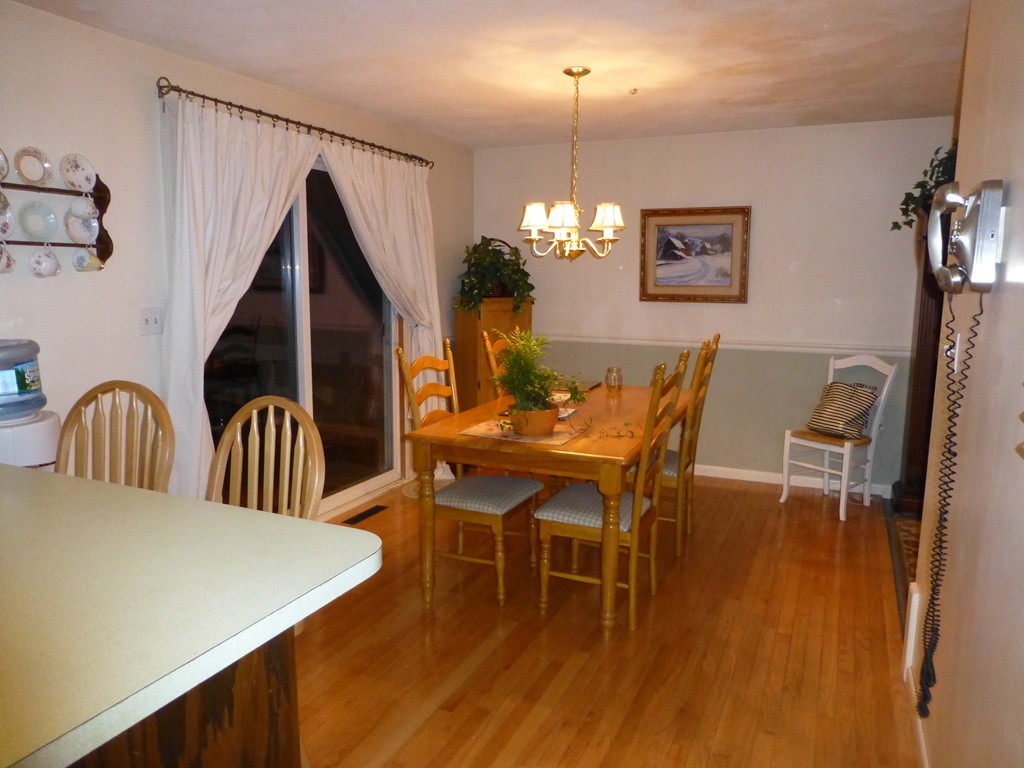 91 Drummer Road, Unit 91 Acton, MA 01720 - Photo 9 of 17 a view of a dining room with furniture and chandelier