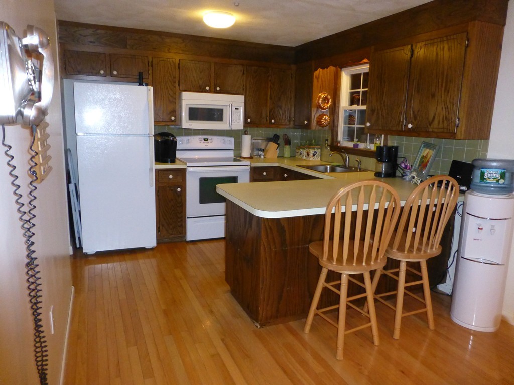 91 Drummer Road, Unit 91 Acton, MA 01720 - Photo 10 of 17 a kitchen with stainless steel appliances a sink a microwave a refrigerator and cabinets