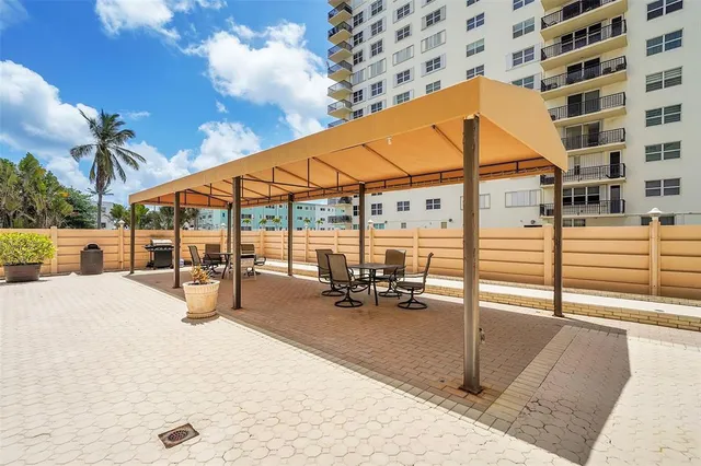 a view of a backyard with a patio and fire pit