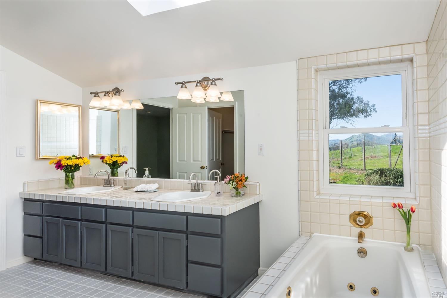 104 Bryan Drive Novato, CA 94945 - Photo 25 of 38 Main bathroom has double sink and jetted tub.