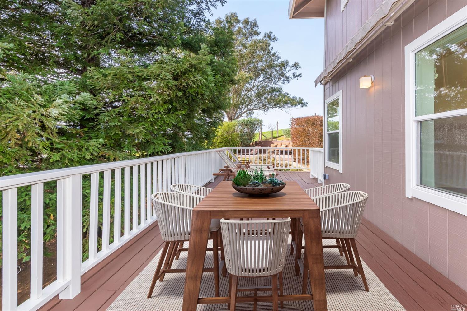 104 Bryan Drive Novato, CA 94945 - Photo 10 of 38 Deck from living room wraps around, this is staged but see above window, awning for shade.