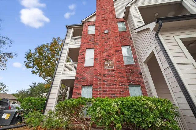 a brick building with a small yard