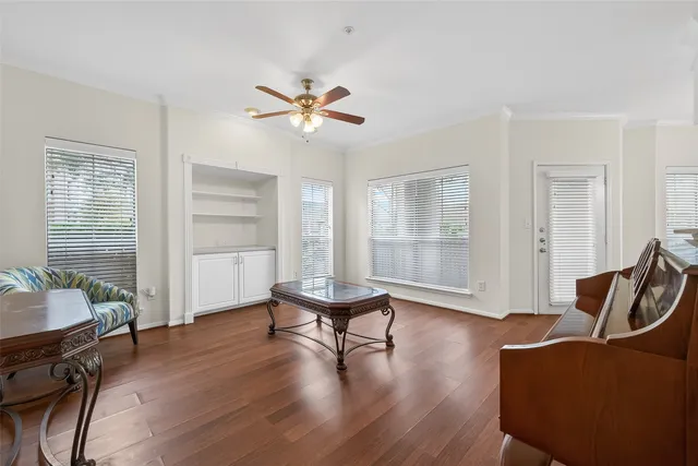 a living room with furniture and wooden floor