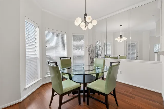 a dining room with furniture and wooden floor