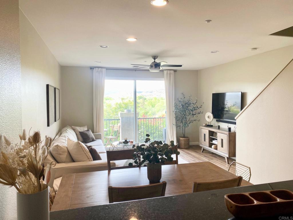 69 Via Sovana Santee, CA 92071 - Photo 2 of 17 a living room with furniture a flat screen tv and a large window