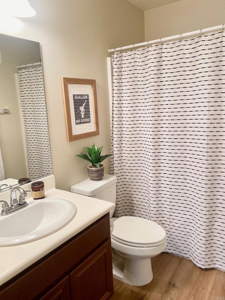 69 Via Sovana Santee, CA 92071 - Photo 6 of 17 a bathroom with a toilet a sink and mirror