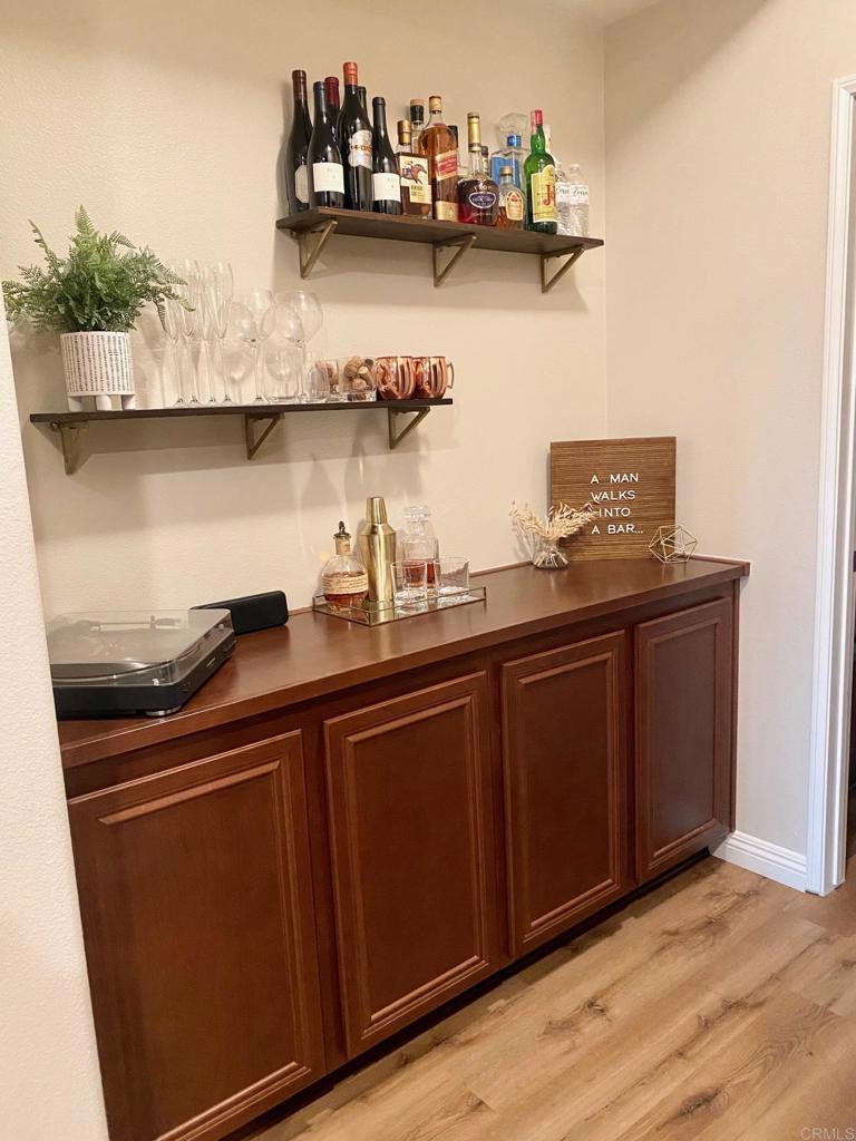 69 Via Sovana Santee, CA 92071 - Photo 7 of 17 a kitchen with stainless steel appliances granite countertop a sink and wooden cabinets