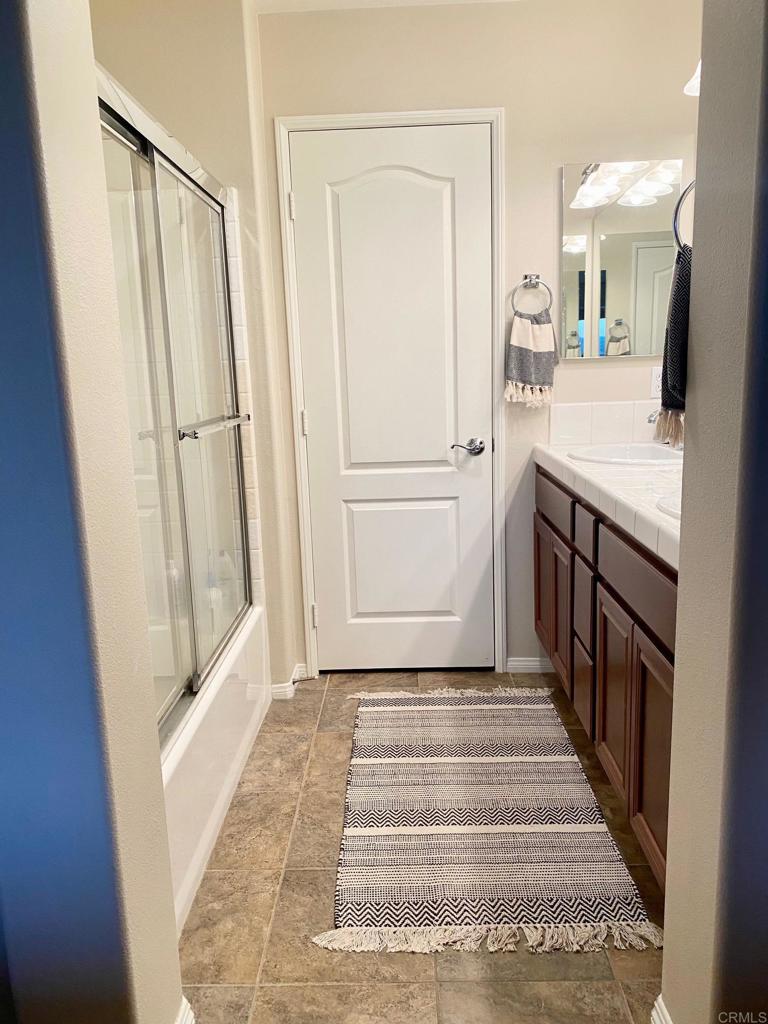 69 Via Sovana Santee, CA 92071 - Photo 10 of 17 a spacious bathroom with a sink and a mirror